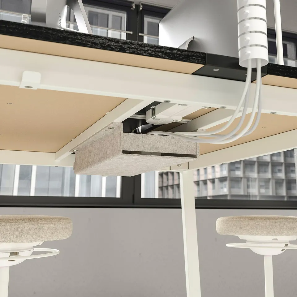 Office cubicles with suspended power cables and led light panels. Cables perfectly aligned, connecting multiple workstations.