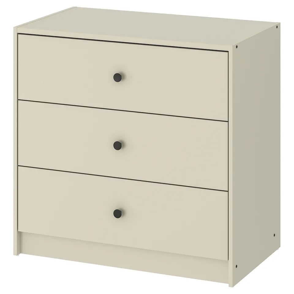 A GURSKEN beige chest of drawers with three drawers, simple design, and circle knobs.