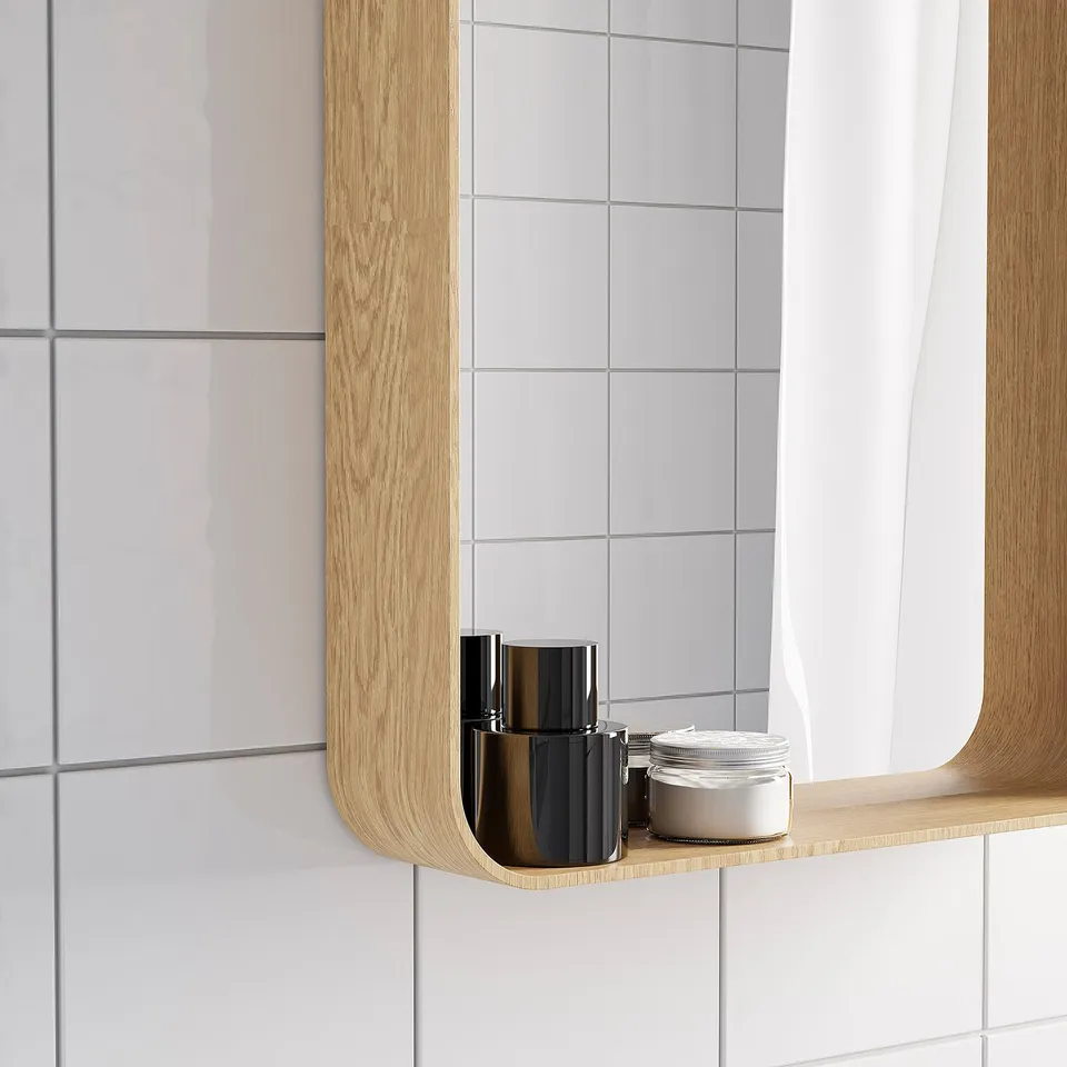 Wooden-framed mirror with shelf holds items, ideal for bathroom.