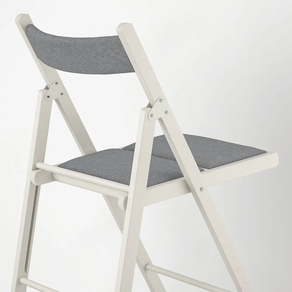 Modern white foldable chair, well-cushioned seat and back, sturdy wooden frame.