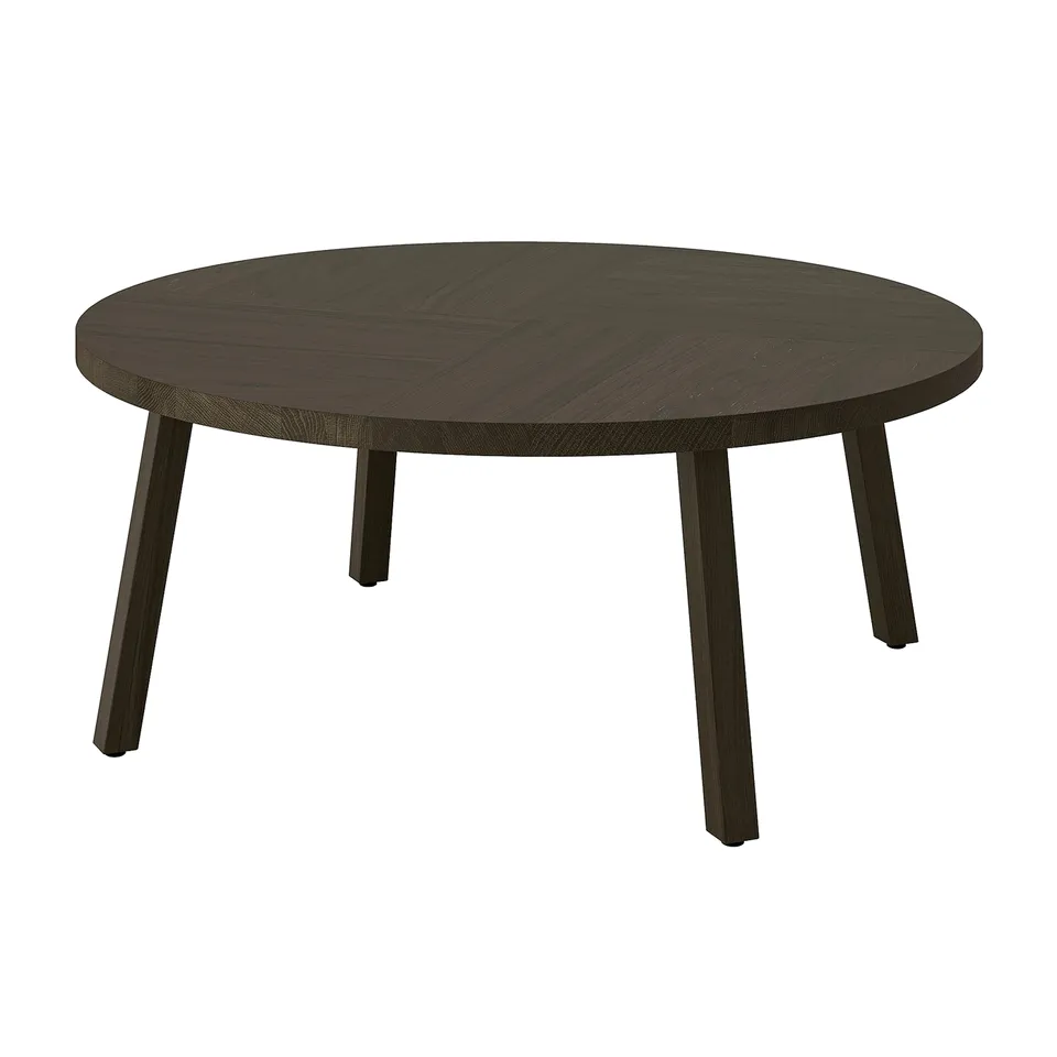 Dark wooden round coffee table with four slim, tapered legs, modern scandinavian design.