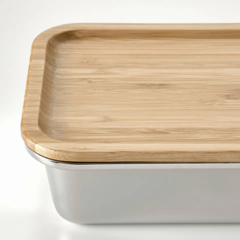 Rectangular stainless steel food container with a tight-sealing bamboo lid. Top is smooth and natural, suitable for refrigerator storage.