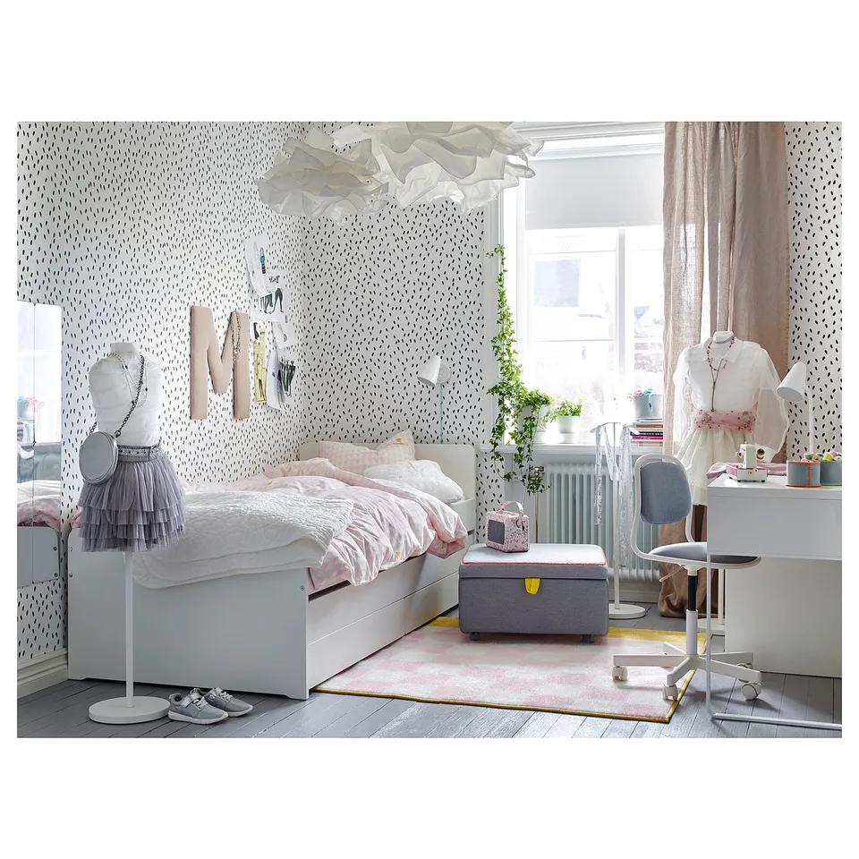 Charming kids bedroom with white SLÄKT bed, pink accents, wall hanging, and desk.