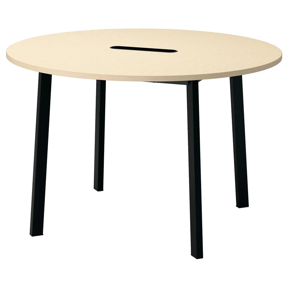 Depicts a MITTZON round conference table with black legs, featuring a light wooden top and integrated cable management.