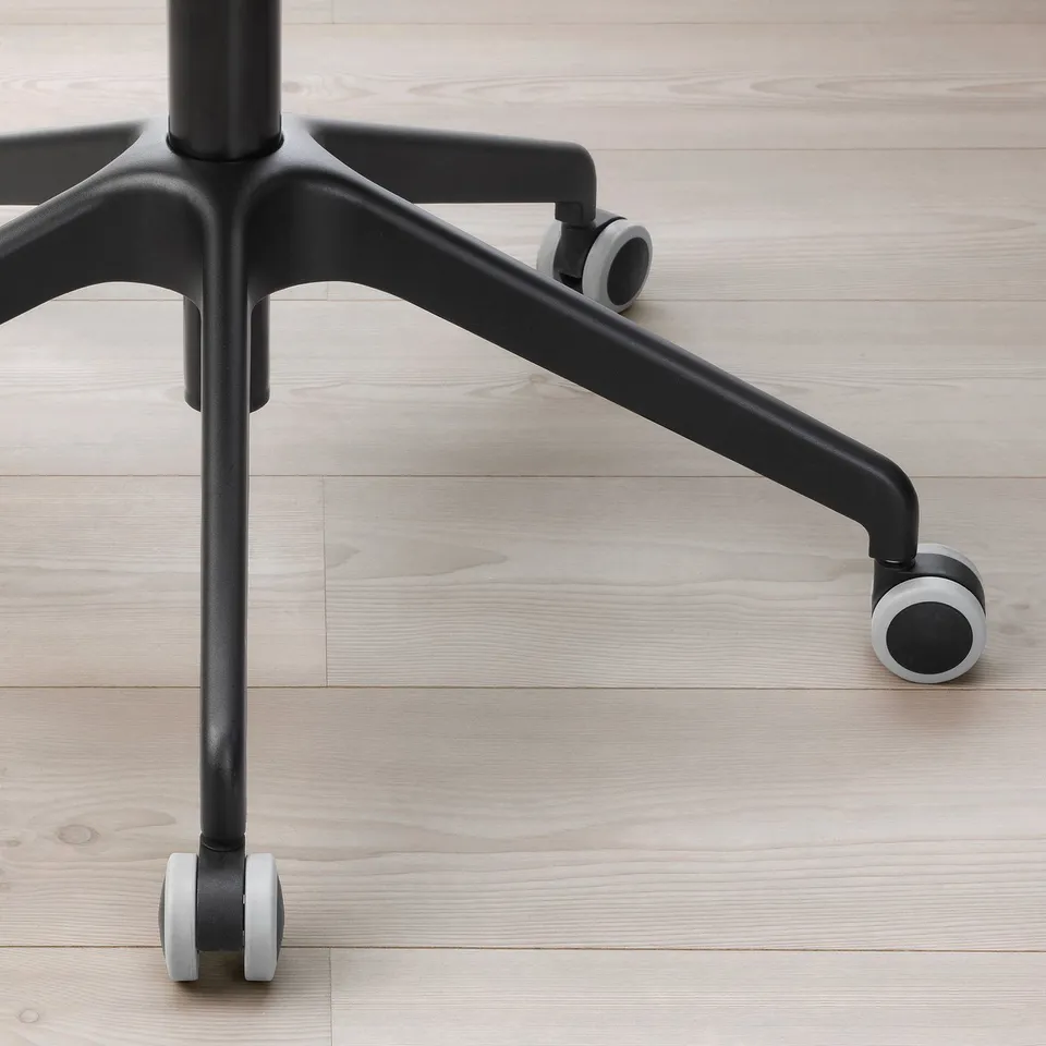 Close-up of black office chair base with sturdy armrests and smooth casters, showcasing durable design and materials.