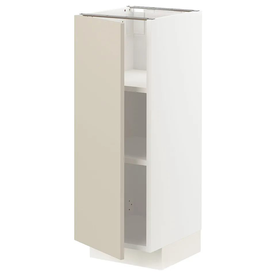 A white METOD kitchen cabinet with beige door and shelves. The cabinet has a rectangular shape and smooth, clean design.