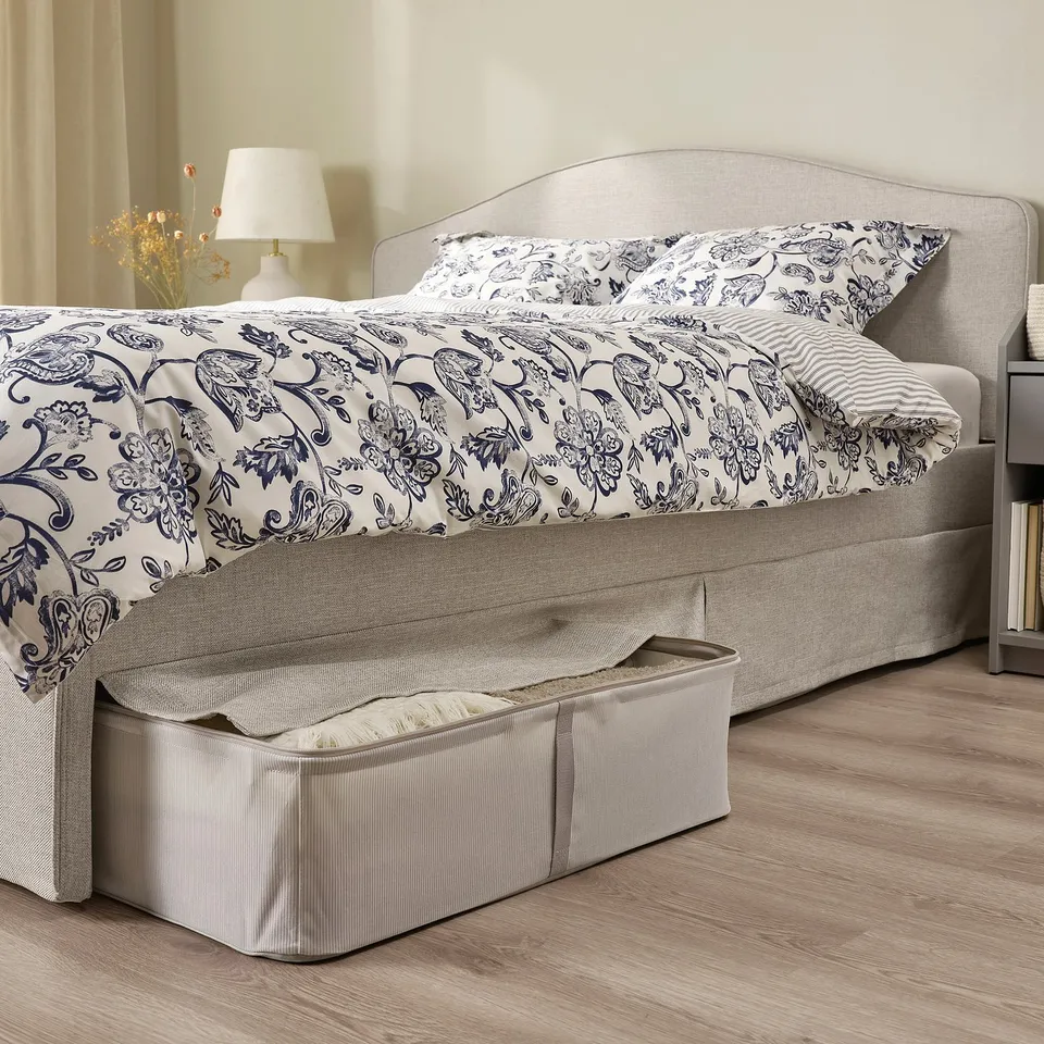 Cosy bed with padded headboard and under-bed storage.