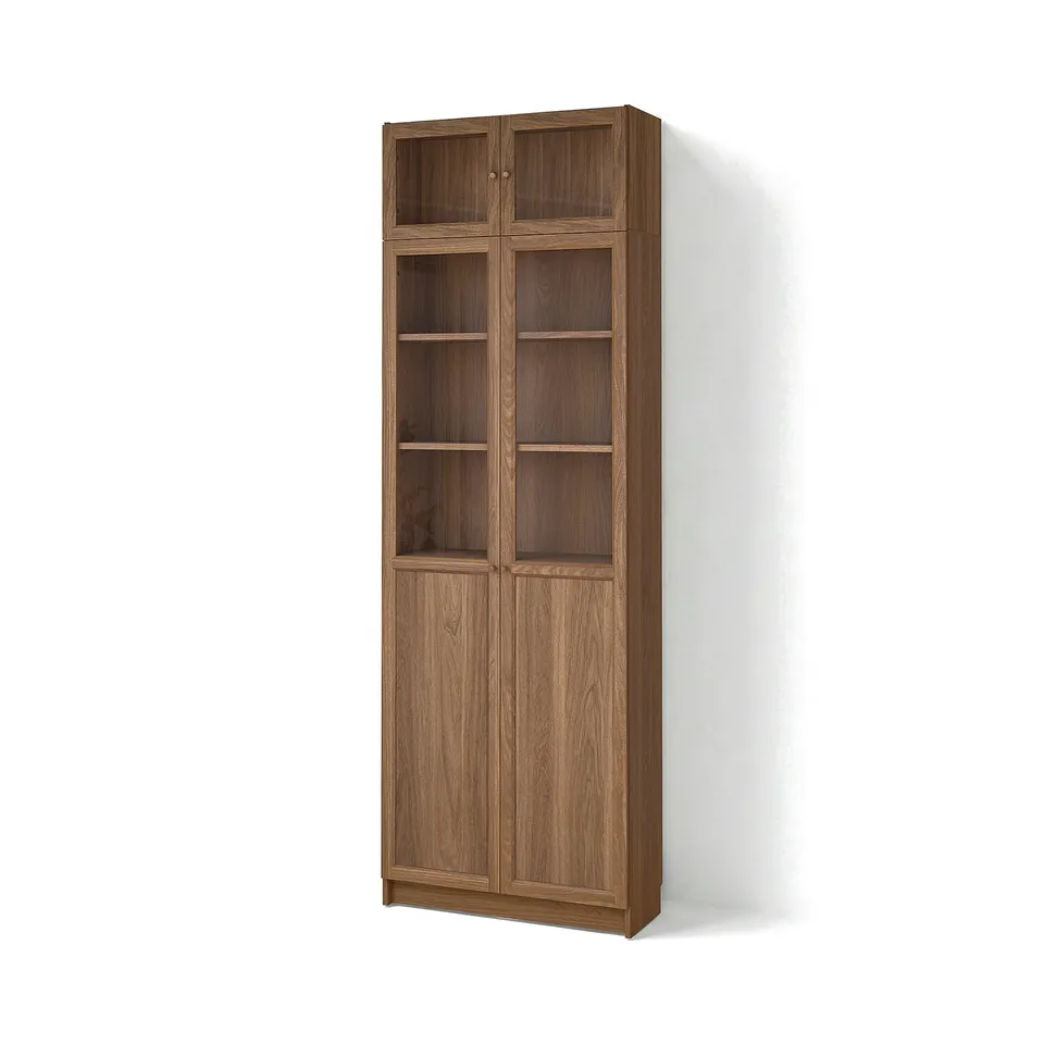 A tall BILLY bookcase with wooden doors and multiple shelves. It has a warm brown finish and a simple, classic design.