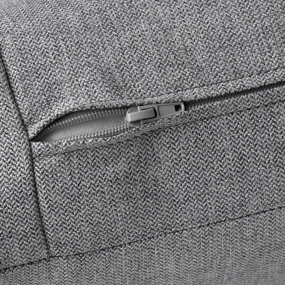 Close-up of grey, textured sofa zip, showing durable, quality fabric and secure, metal zip detail.