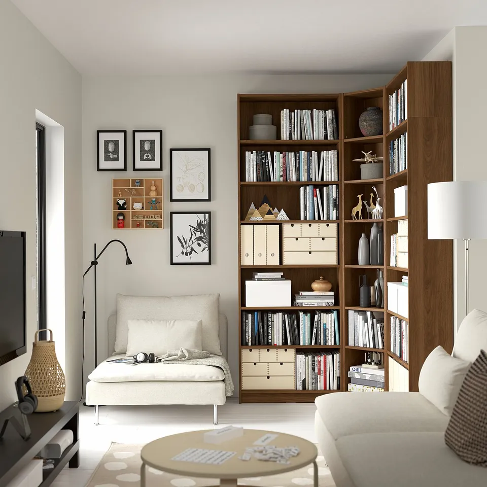 Cosy living room with BILLY bookcase, white couch, lamp, and puzzles.