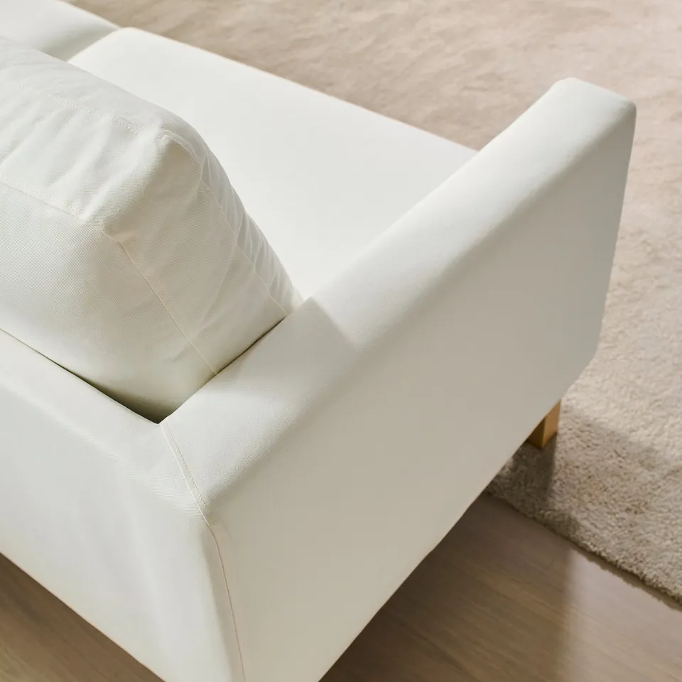Close-up of a sleek, white sofa with clean, square lines and supportive cushions, showcasing its modern design and high-quality upholstery.