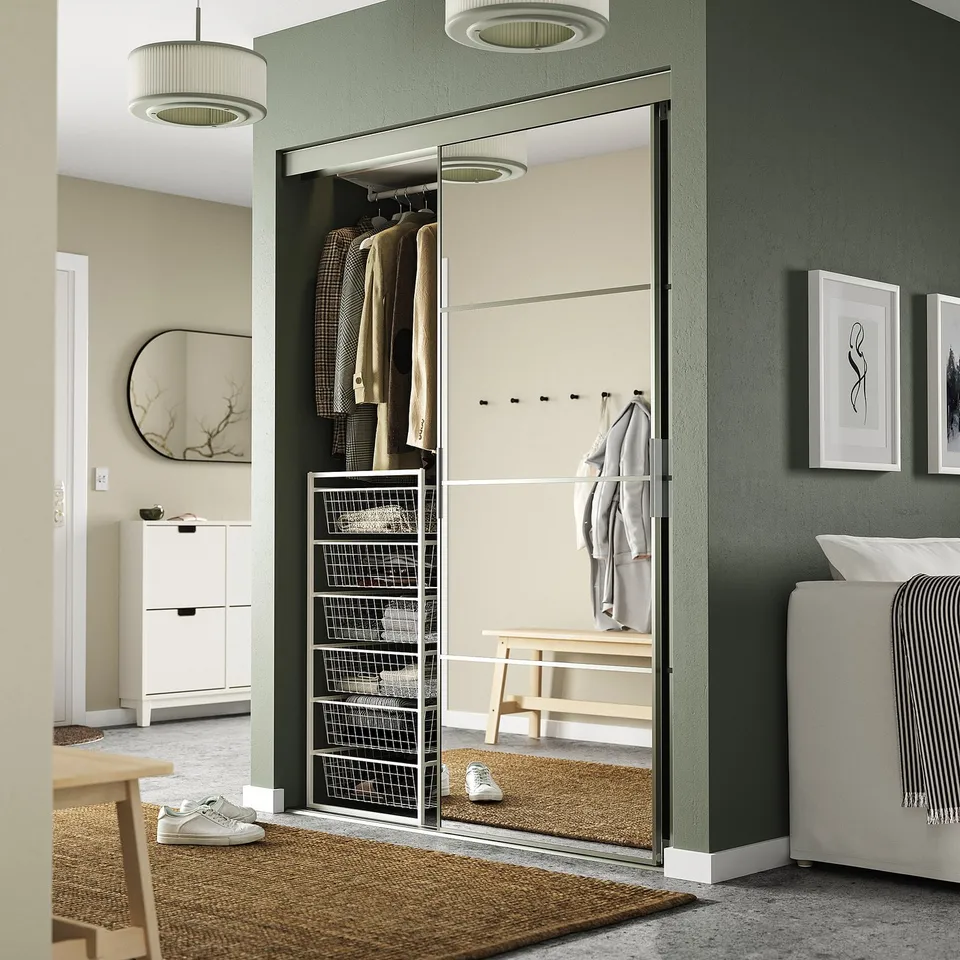 JONAXEL storage unit with mirrored doors organises clothes, maximises wall space between bed and door.