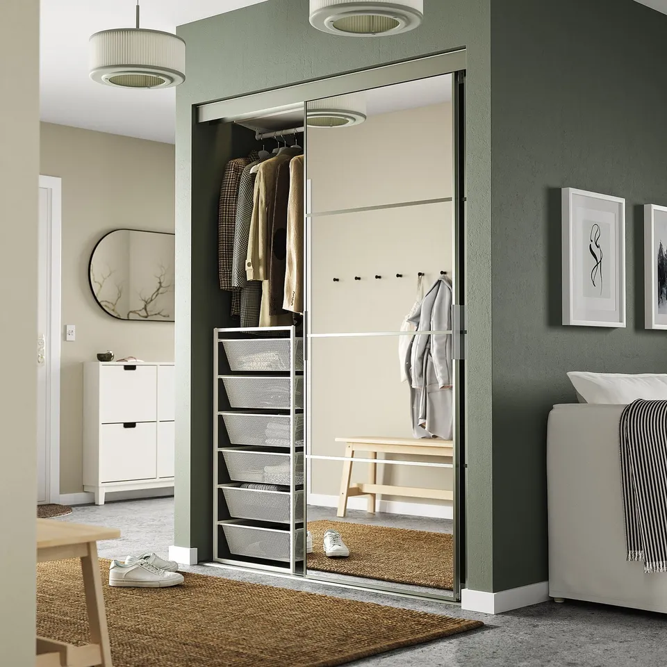JONAXEL closet with mirrored doors, hooks, shelves & baskets, maximising space.