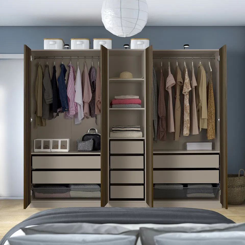 Large open wardrobe displaying hangers, shelves, and drawers for organised clothing storage.