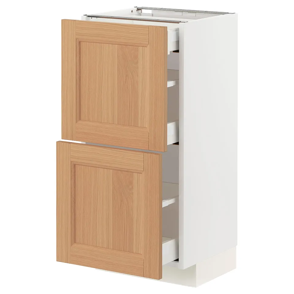 A METOD kitchen cabinet with oak drawer fronts, featuring two drawers and a door. The cabinet is white and has a modern design with a sturdy frame.