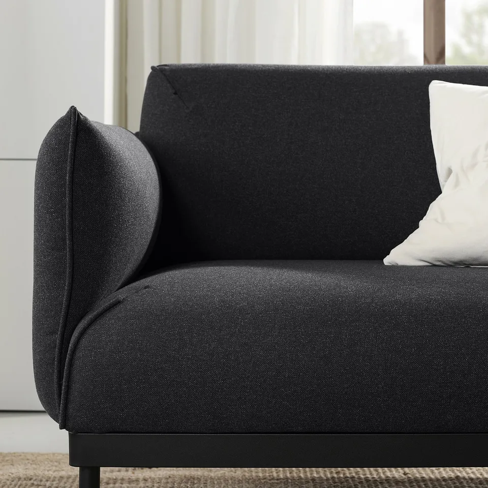 The ÄPPLARYD sofa, sleek and dark grey, modern and comfortable, with clean lines and supportive cushions.