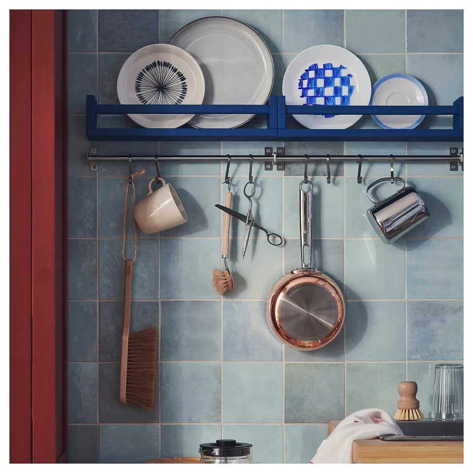 KUNGSFORS blue storage shelves, stainless hooks, kitchen tools, plates, mugs, and utensils neatly organised.