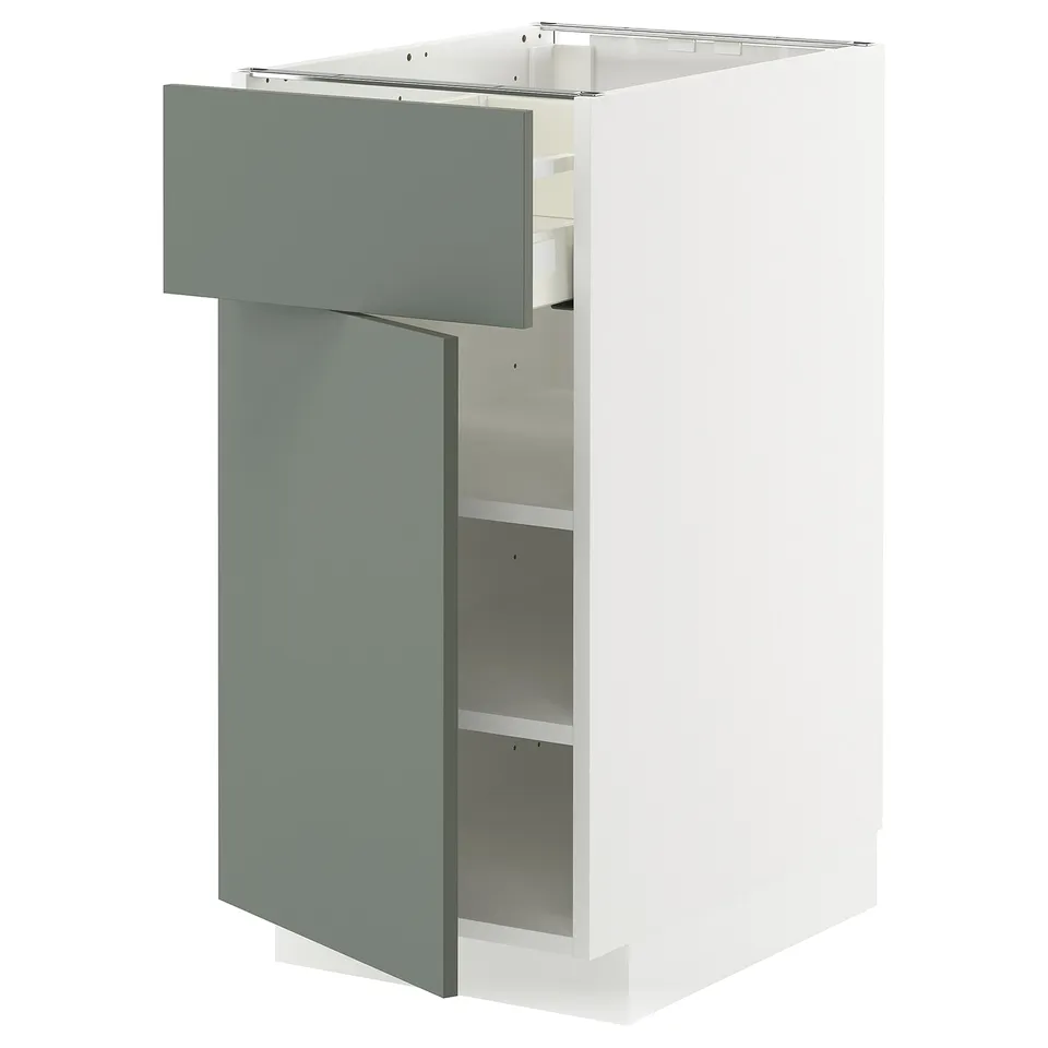 A white METOD kitchen unit with a gray-green drawer and two shelves. Modern, minimalist design with smooth edges.