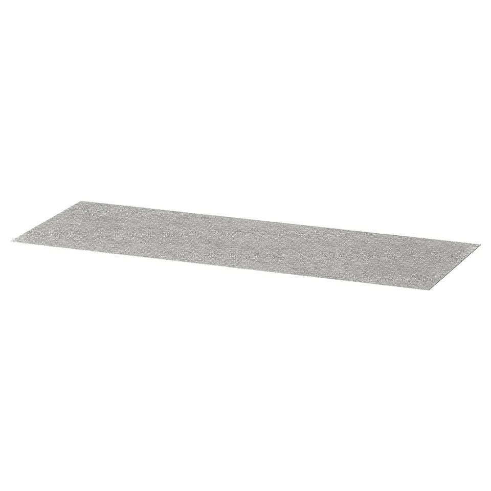 A grey KOMPLEMENT drawer mat, rectangular, made of polyester with a dotted surface design.