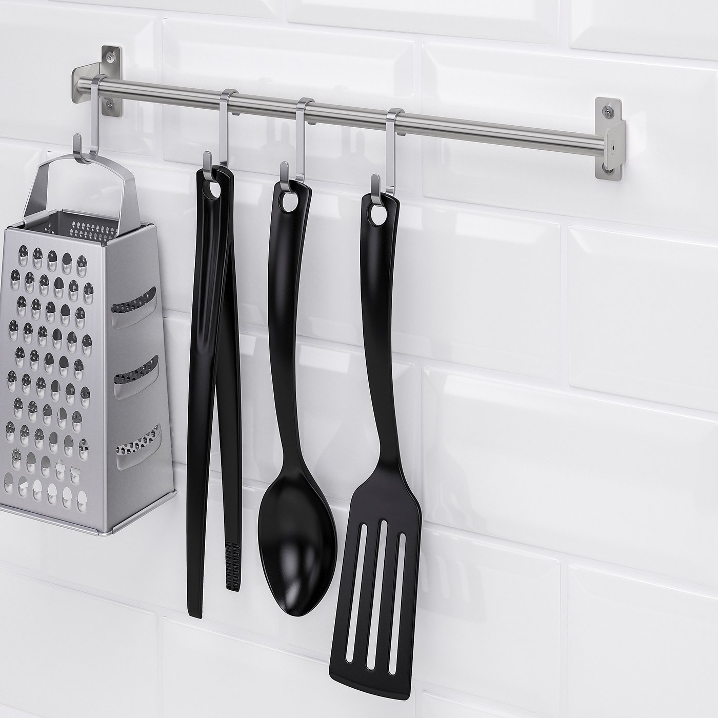Kitchen tools hang from a wall-mounted rail, saving workspace. A grater and ladle are among the items displayed.