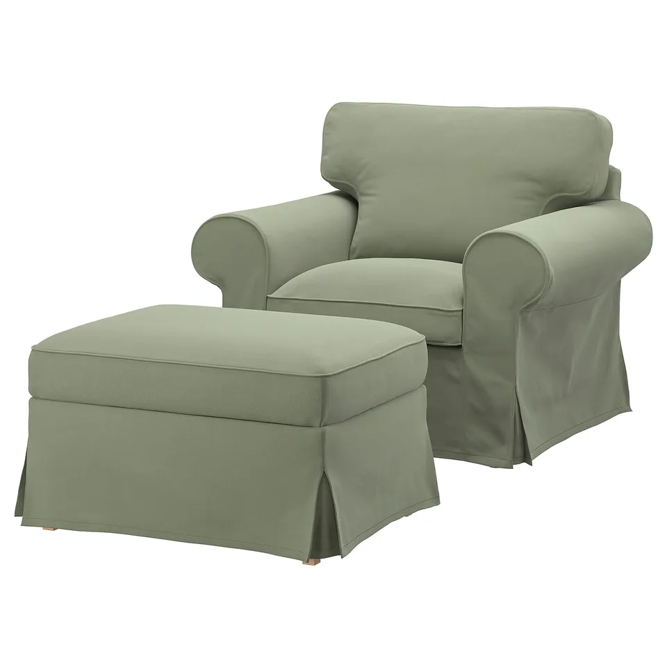 An EKTORP armchair with matching footstool in light green. The set rolled arms, high back, and a classic design with cushioned comfort.
