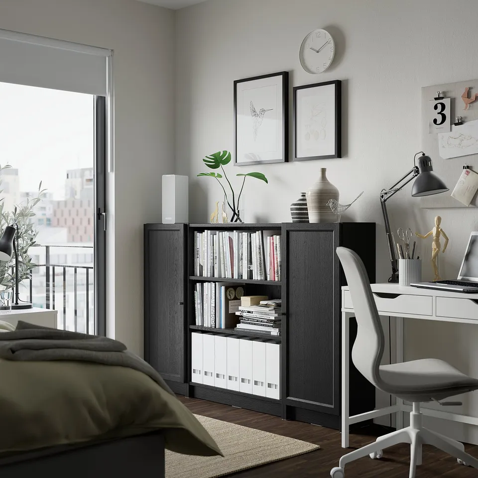 Modern workspace with BILLY bookcase, desk, chair, and decor.