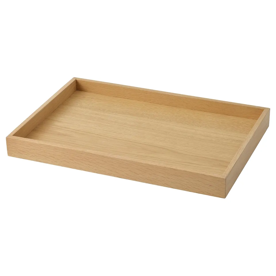 A STOCKHOLM 2025 wooden tray. Light brown, rectangular, with smooth edges and a natural wood grain design. Perfect for serving or display.