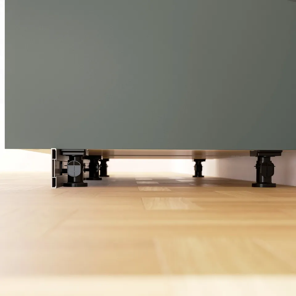 Kitchen cabinet legs adjusted for stability on uneven floors.