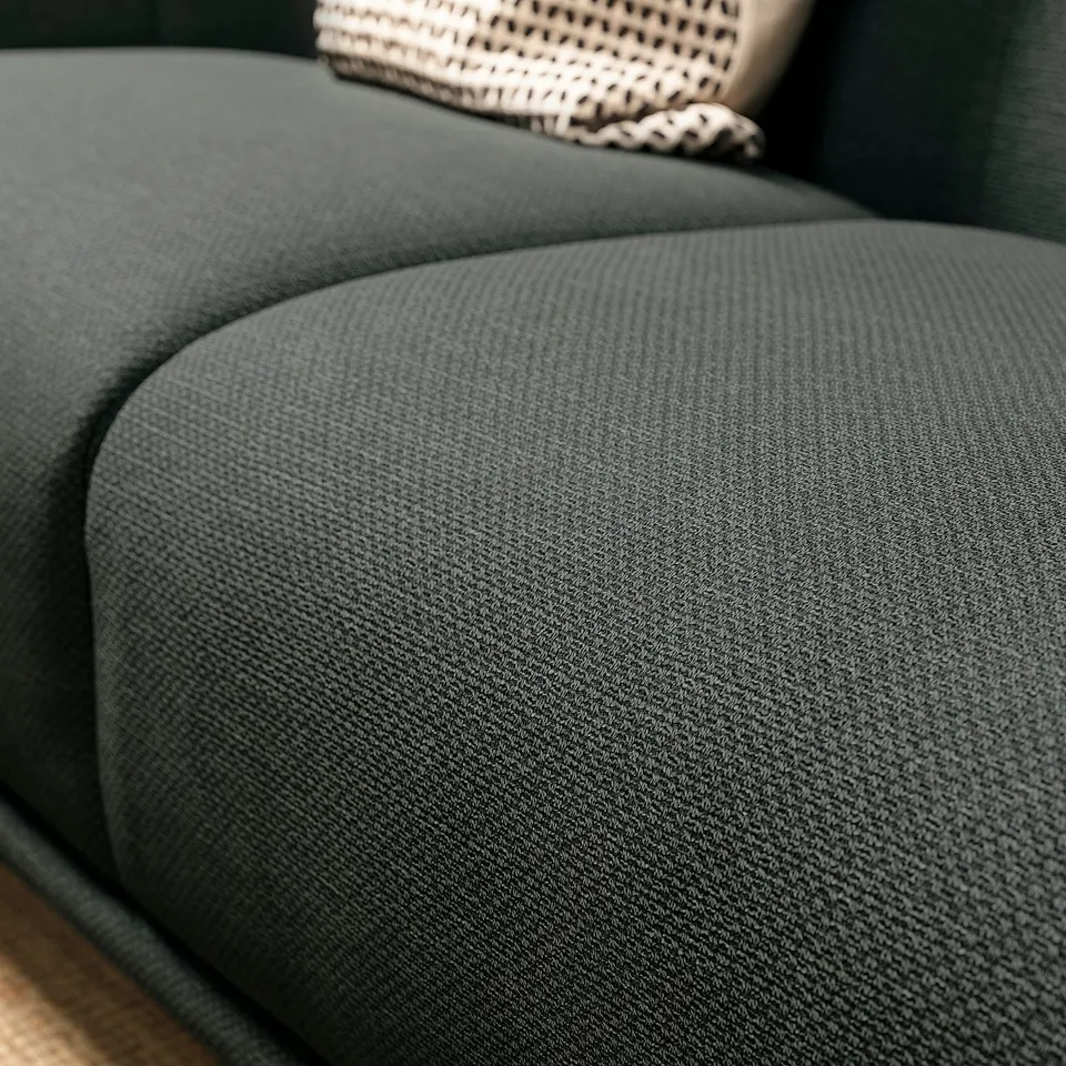 Dark green VISKAFORS sofa, curved arms, soft fabric, cosy design.