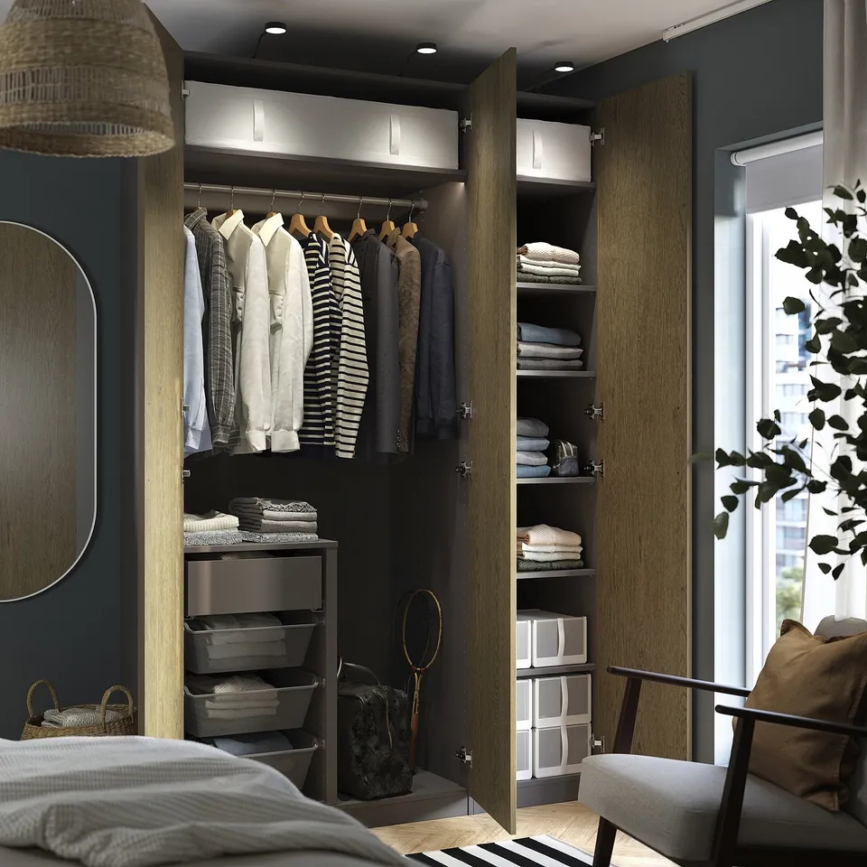 Modern wardrobe with lighting, shelves, drawers, and mesh baskets for clothes.