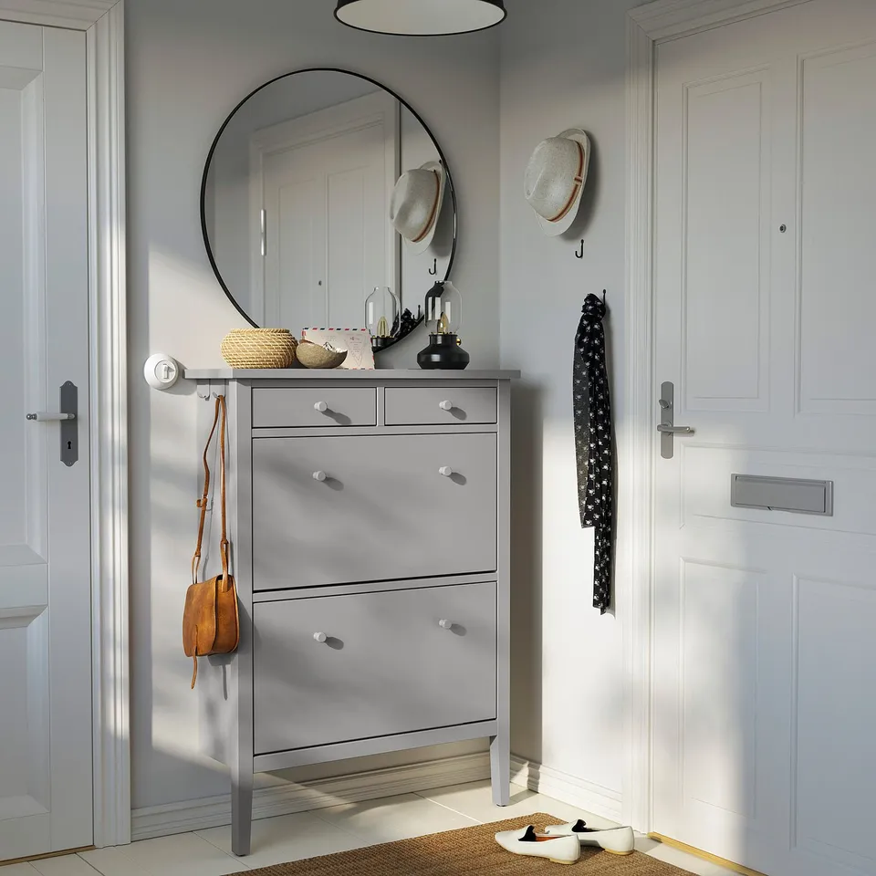 Grey GULLABERGh shoe cabinet with wooden knobs, fits hallway, provides ample storage.