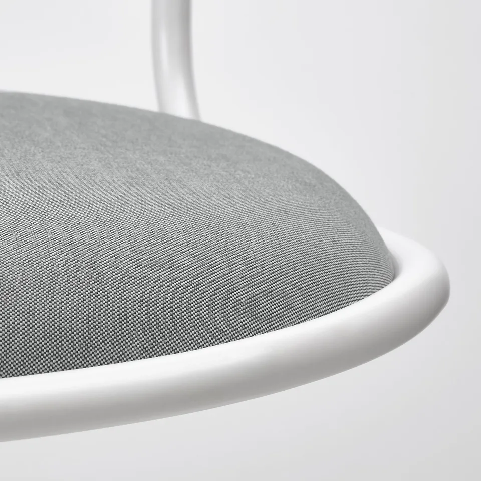 Close-up of sleek, modern chair seat showing quality foam and clean, white edge.