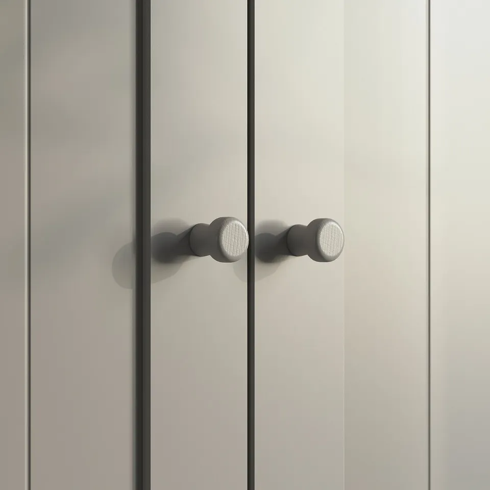 A white GULLABERG cabinet door with round, horizontal, silver handles.