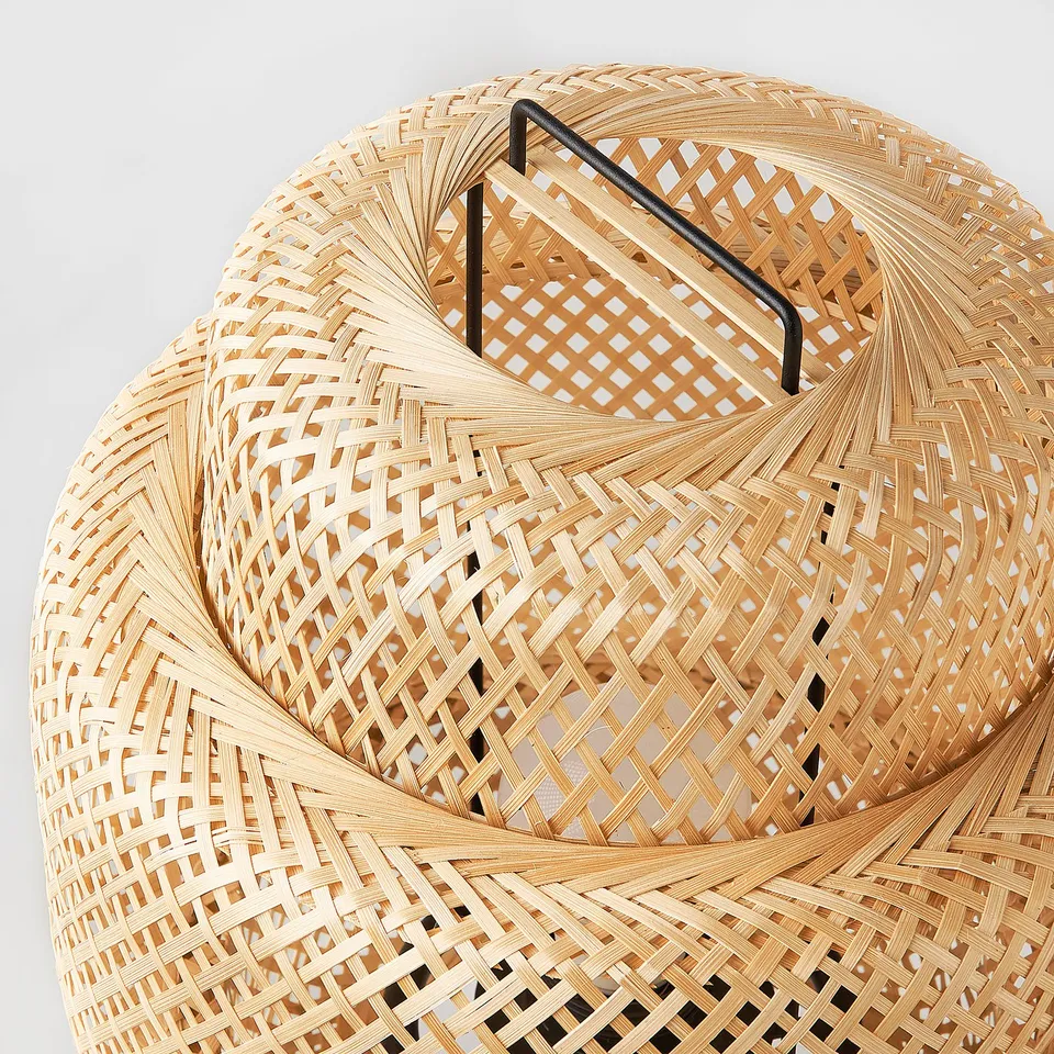 Woven bamboo lamp, intricately braided, with sleek metal handle. Modern design, natural material.