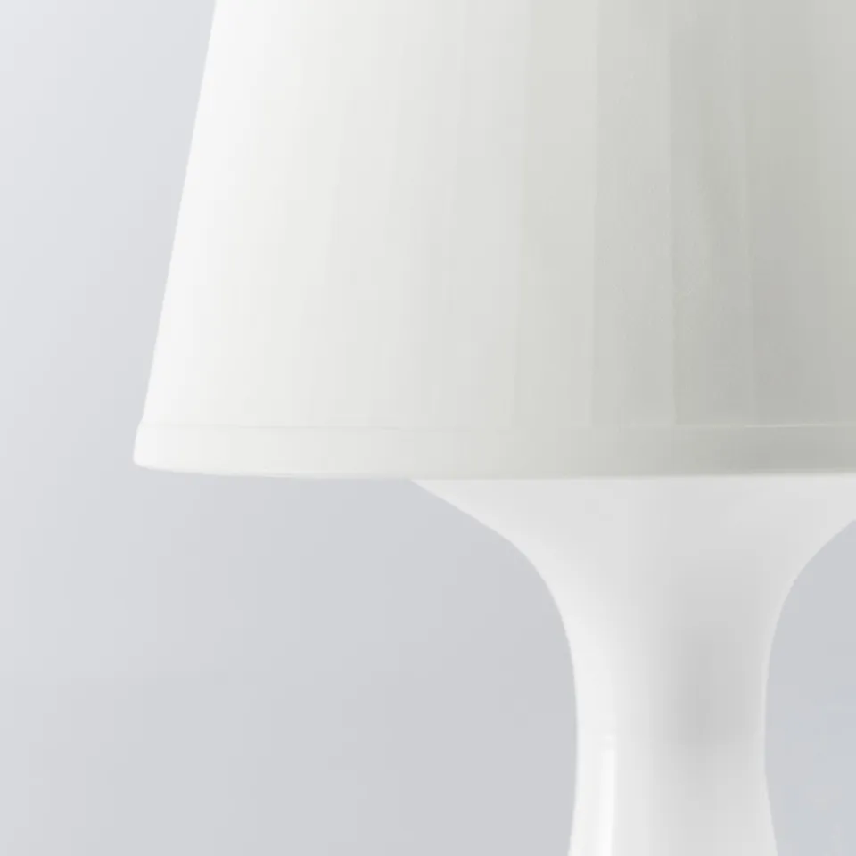 Soft, modern lamp featuring smooth curves & warm, inviting light.