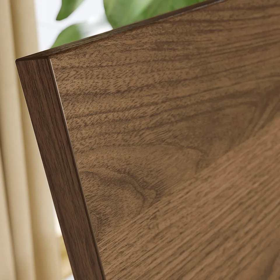 Dark wooden bed frame corner, showcasing high-quality finish and sleek design.