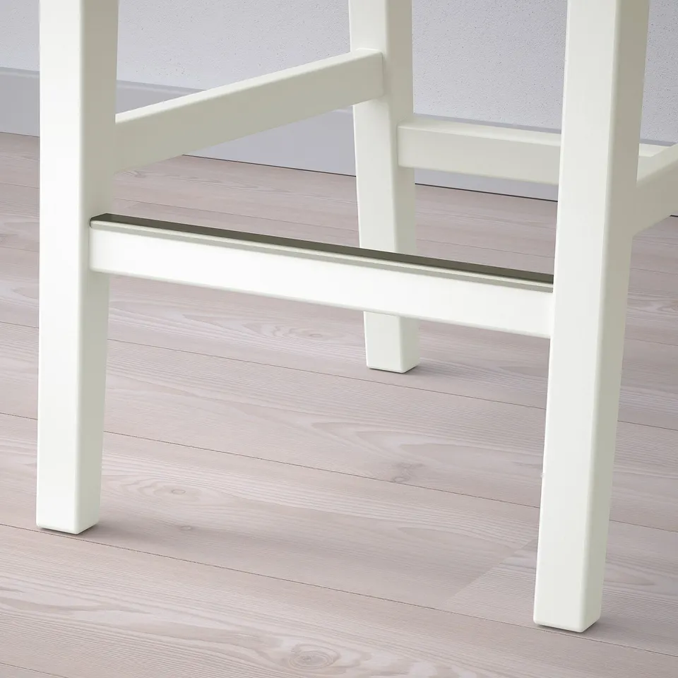 Modern bar stool with sturdy wooden legs and metal footrest. Ideal for kitchens or dining areas.