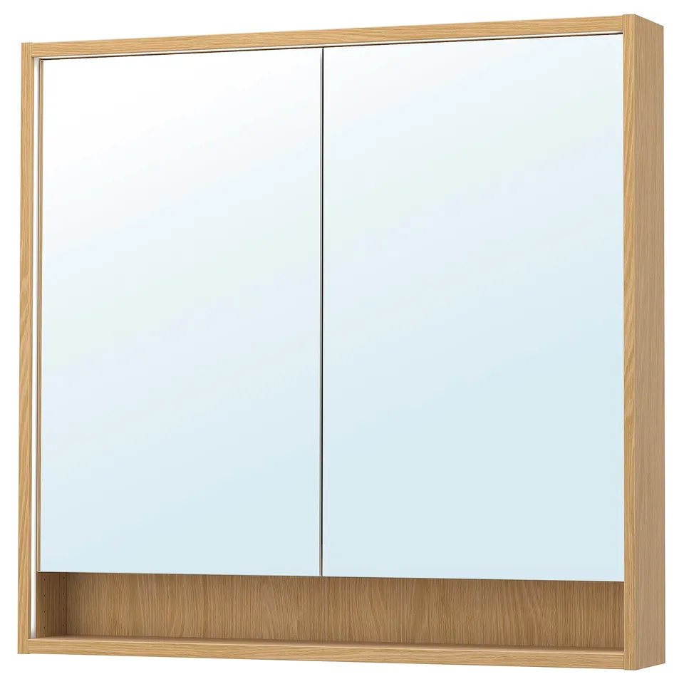 A FAXÄLVEN mirror cabinet in light oak, featuring integrated lighting and a storage shelf.