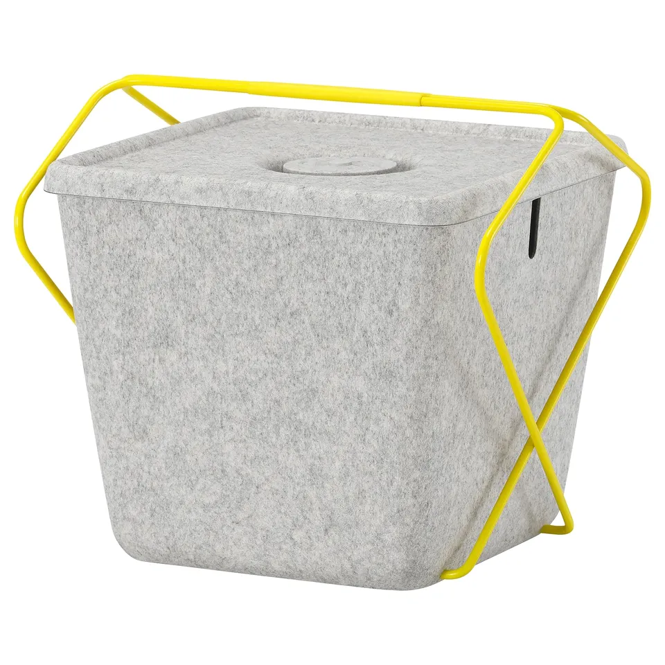 Grey BRÄNNBOLL basket with yellow handles, lid, and side hole for gaming accessories.
