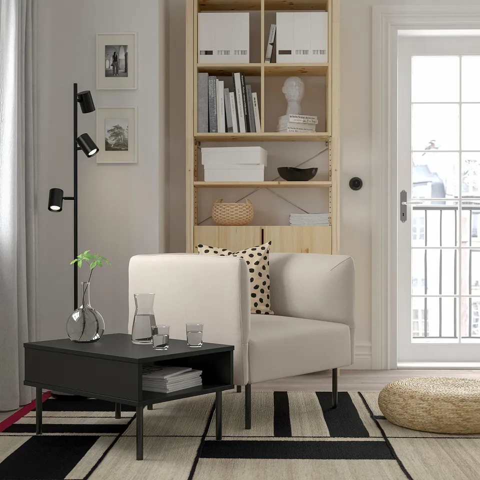 Modern living room with LILLEHEM sofa, bookshelf, coffee table, rug, lamp, artwork, and balcony.