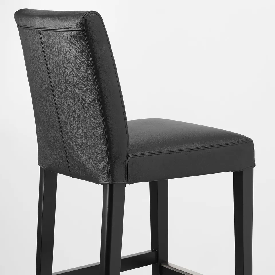 Modern barstool with sleek black leather seat and backrest, offering cushioned comfort and stylish support.