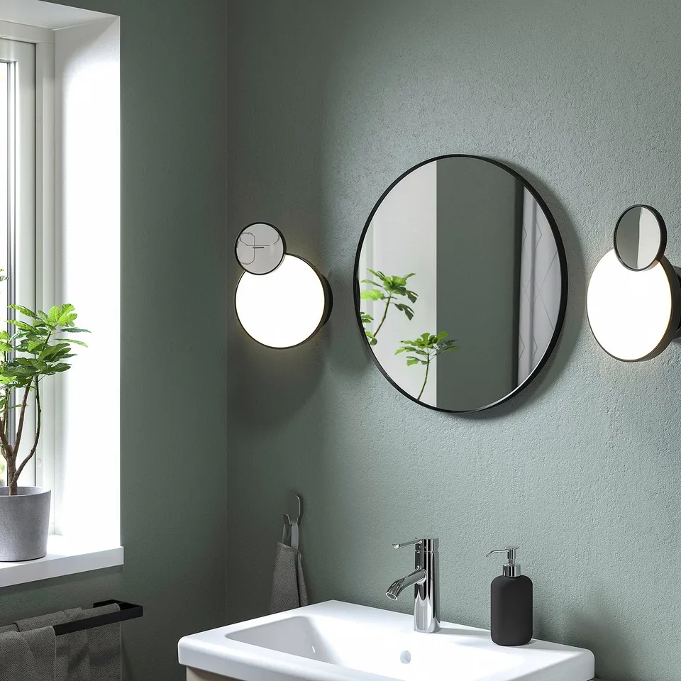 LINDBYN mirror: large, round, black, modern bathroom reflection.