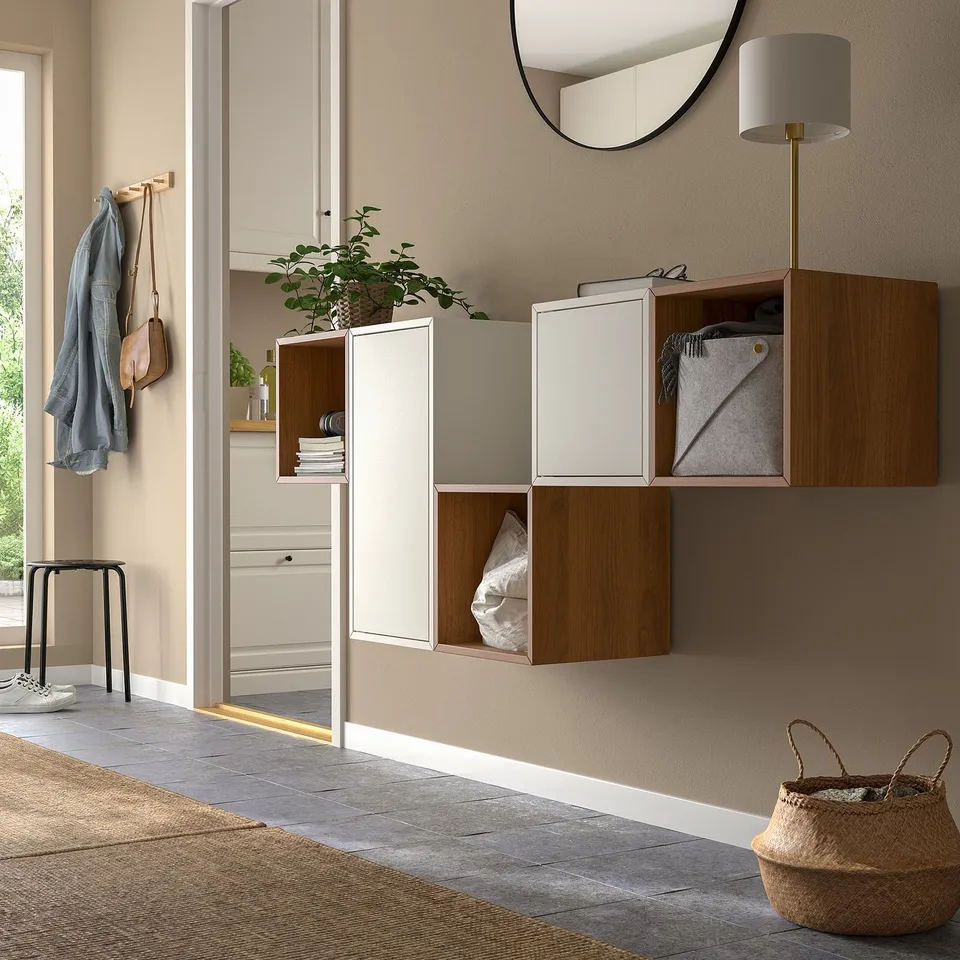 Modern entryway with EKET cabinets, lamp, coats, and basket.