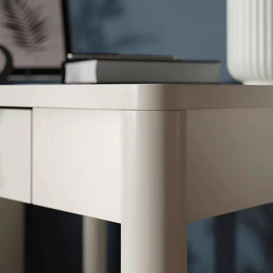 Well-crafted white desk with smooth, soft-close drawer; quality detailing.
