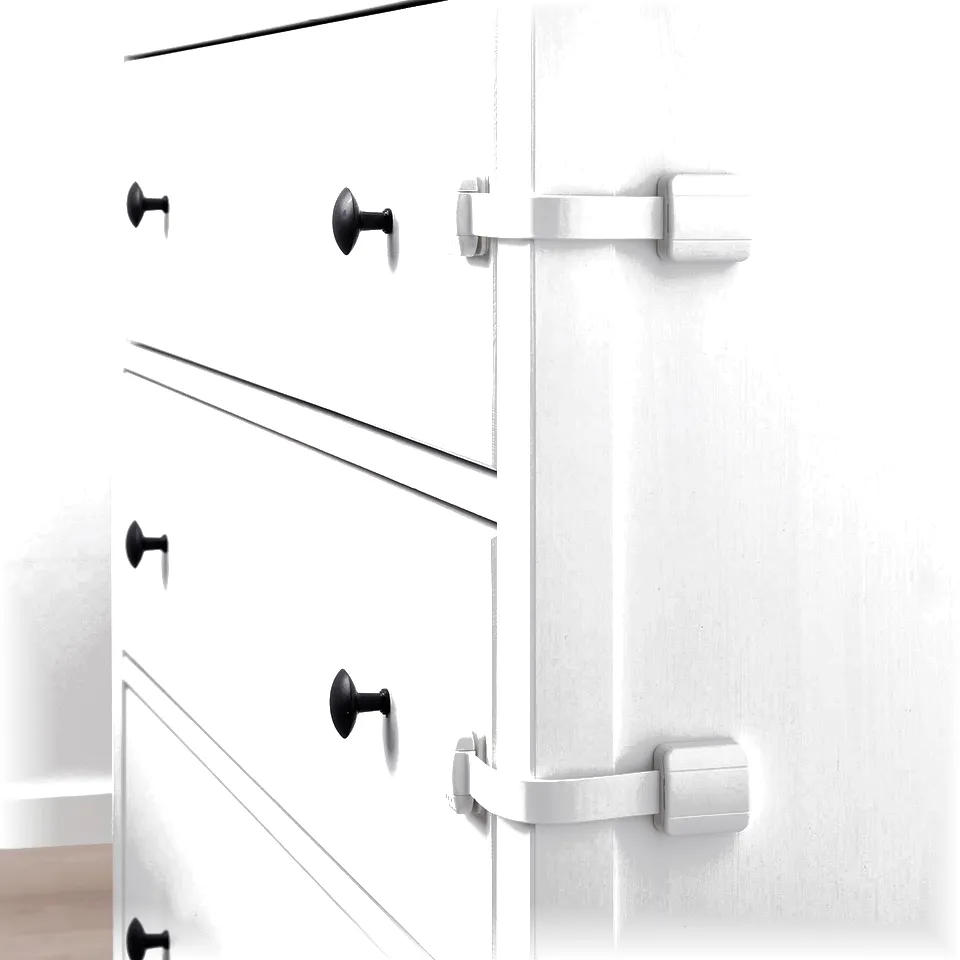 White furniture has black handles and child safety latches attached to the edges of drawers and a door.