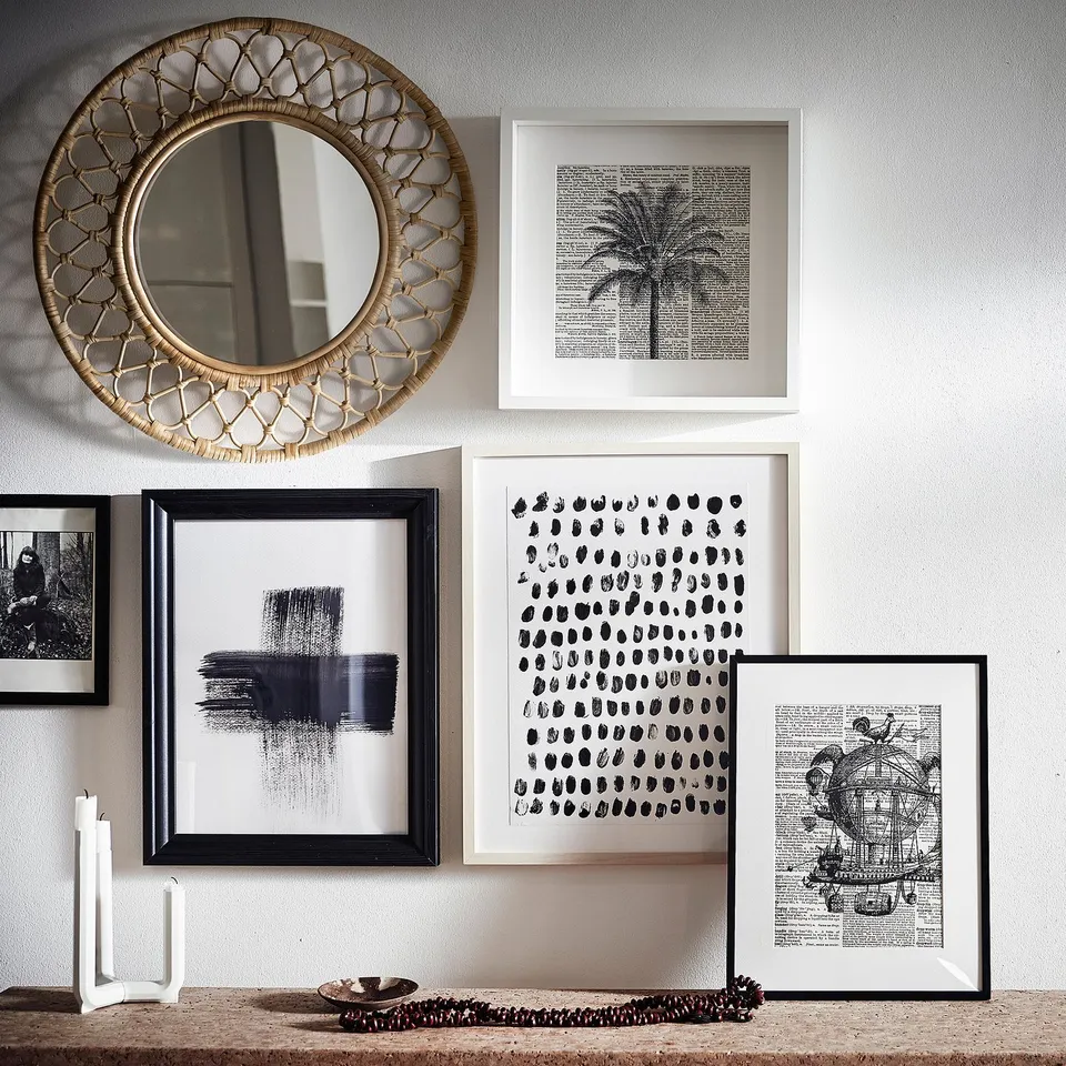 Rattan mirror, black-white prints, candle holder