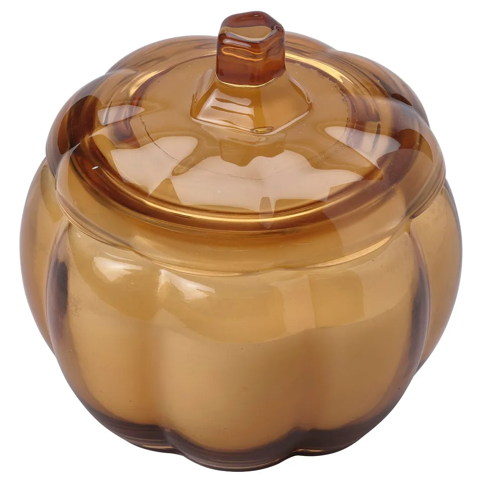 HÖSTAGILLE amber glass pumpkin-shaped candle holder with lid. Sleek design, smooth texture, and warm autumnal hues.