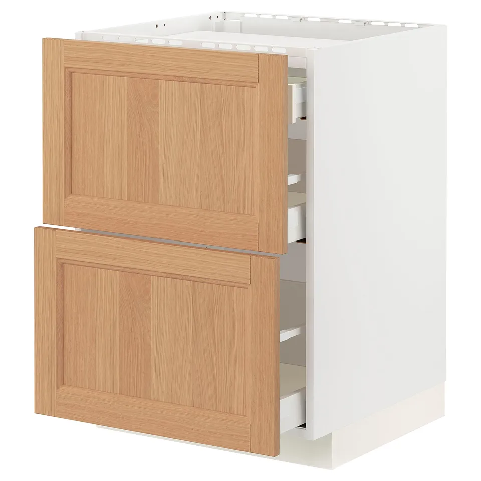 A METOD kitchen cabinet with vedhamn oak fronts. It has two drawers and a white frame. The cabinet is rectangular with a natural wooden finish.