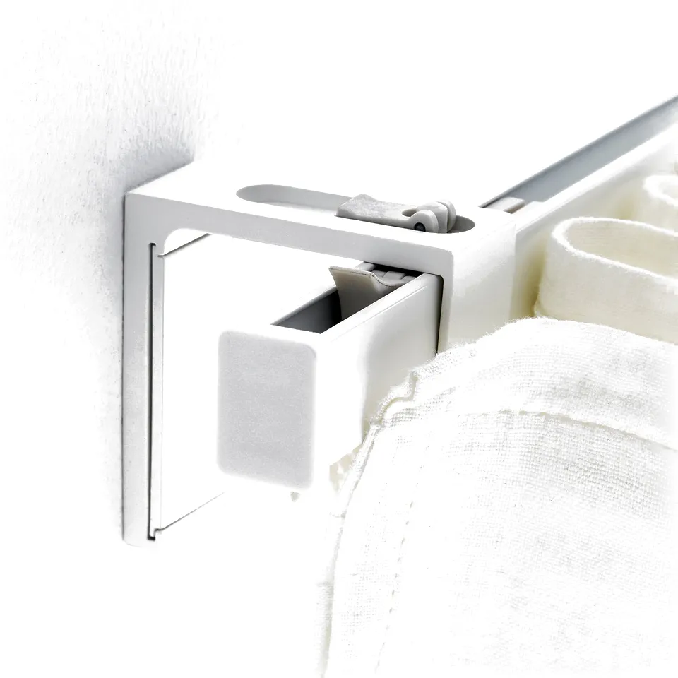Wall-mounted curtain bracket. Holds rail close to wall, blocking light for better sleep.