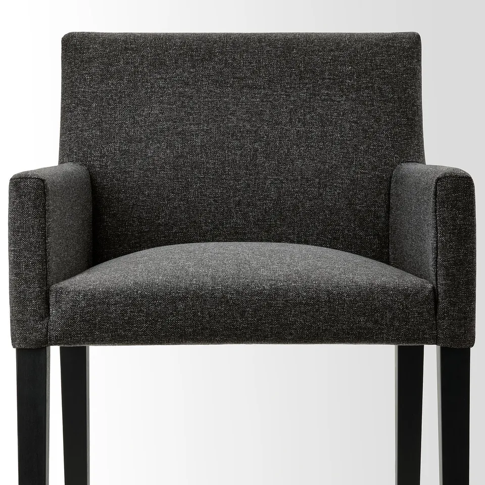 Chair with dark grey upholstery and wooden legs, featuring sturdy construction and clean lines for modern appeal.